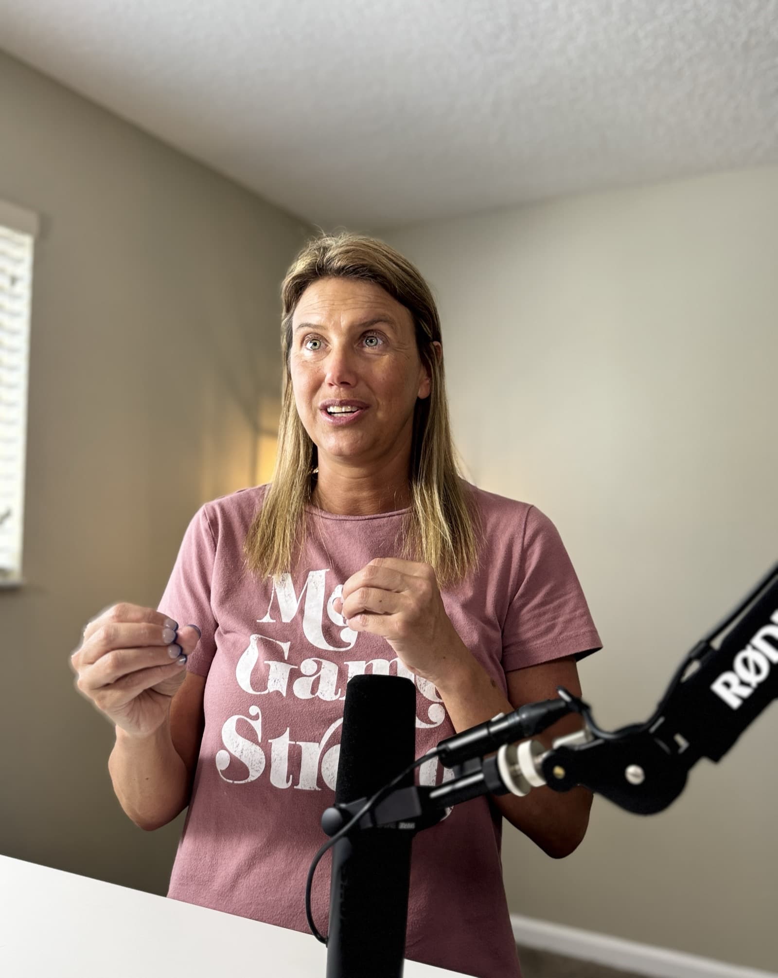 Jess Laverde speaking into a microphone during a conversation at home.
